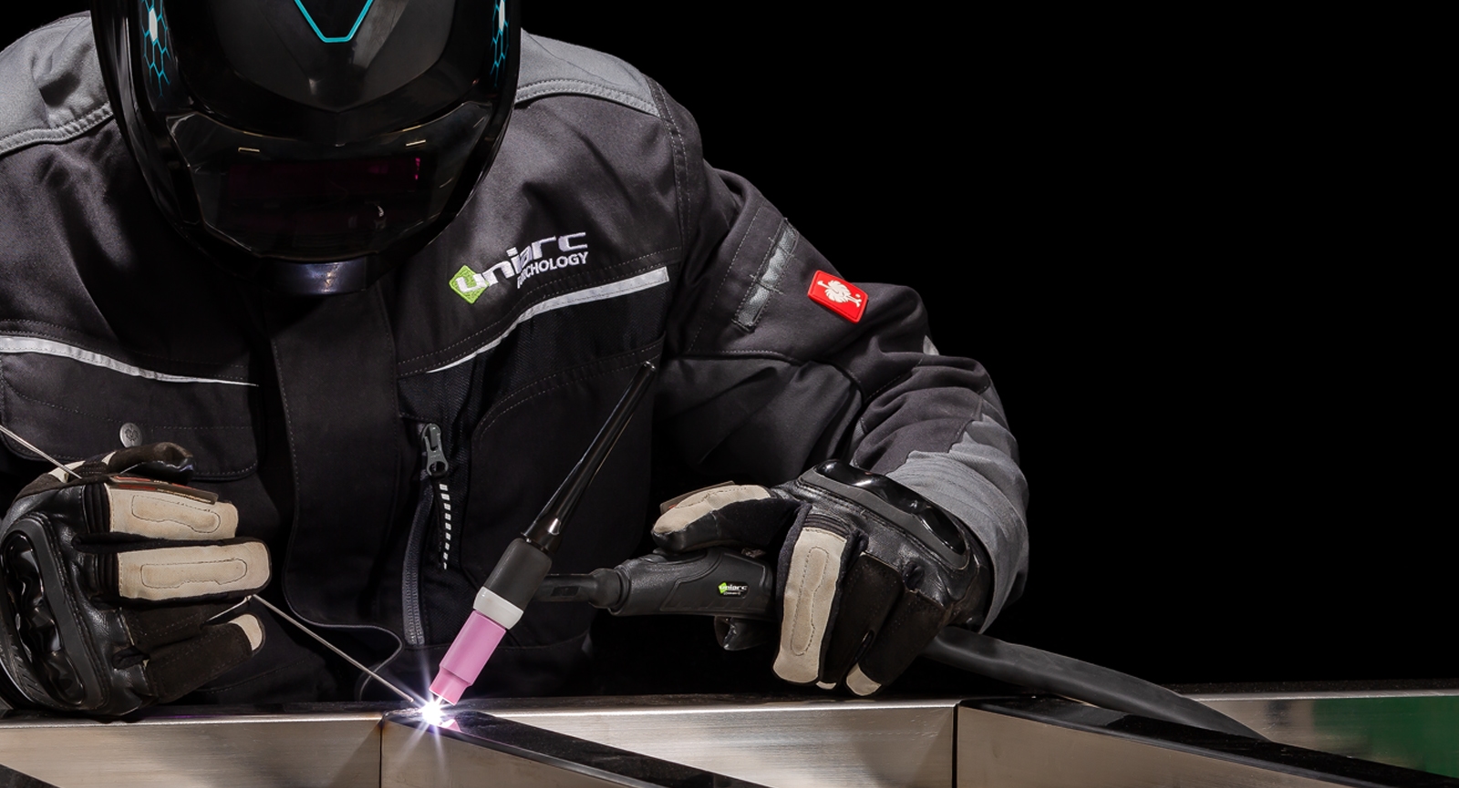 A welder using a neutral branded Uniarc Tig welding Torch.